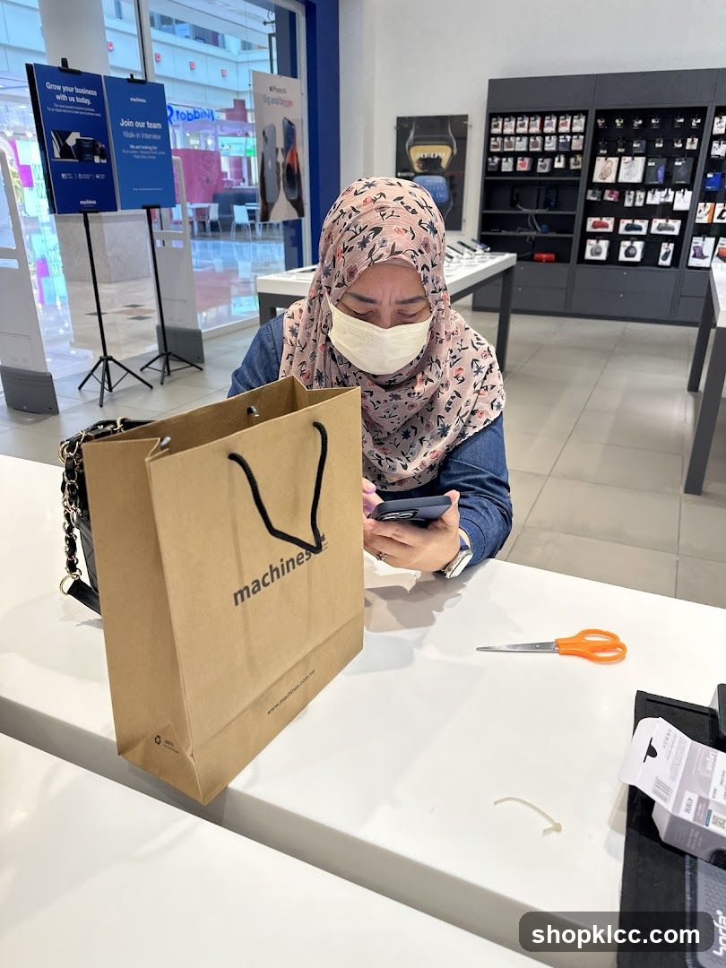 Woman using phone in electronics store