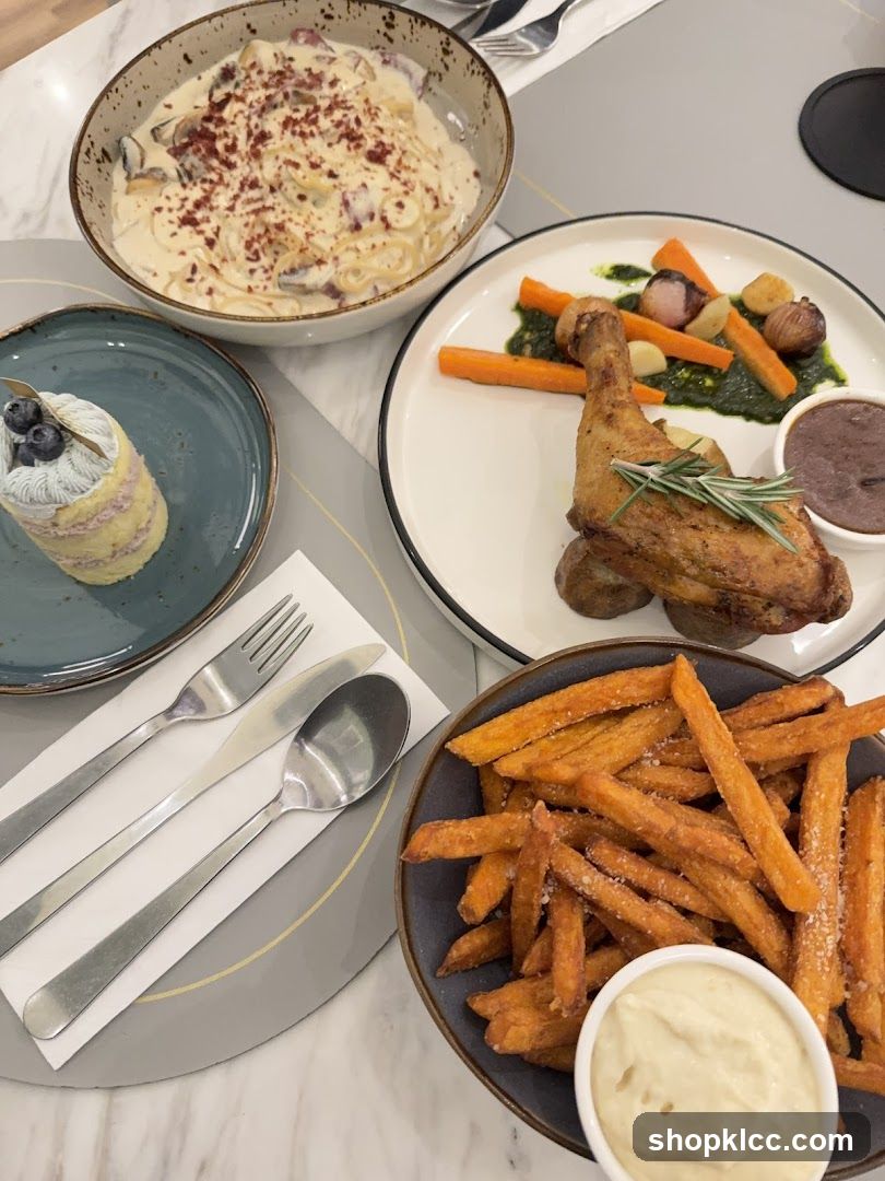 A meal with pasta, chicken, fries, and cake