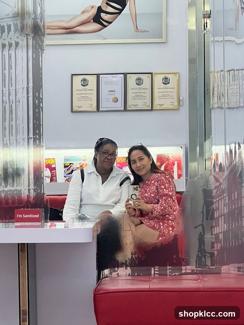 Two women posing for a selfie in a salon