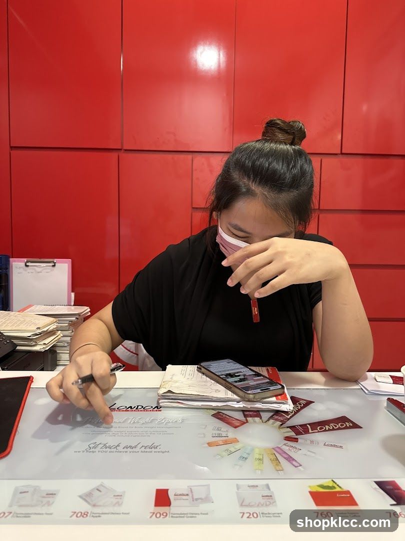 Woman at Desk with London Weight Experts Branding