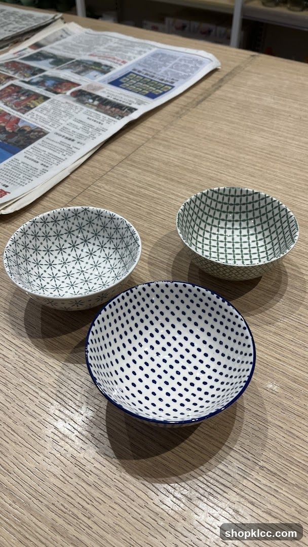 Three patterned ceramic bowls on a wooden table