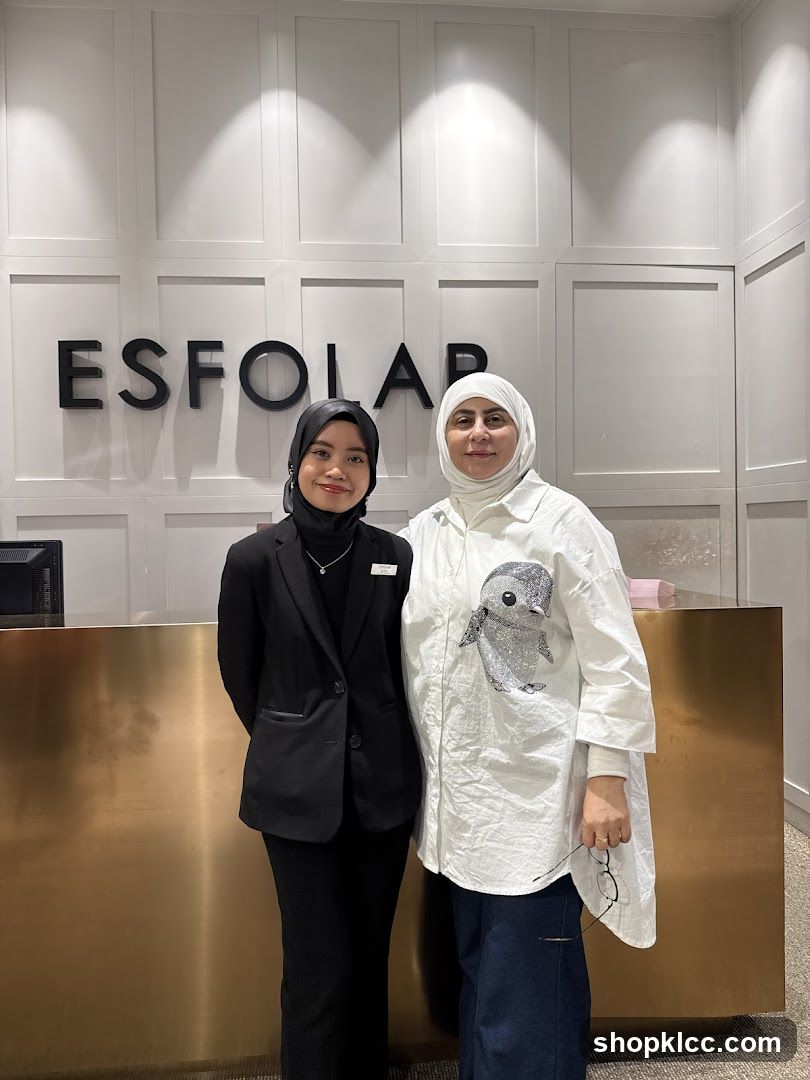 Two women standing in front of a reception desk