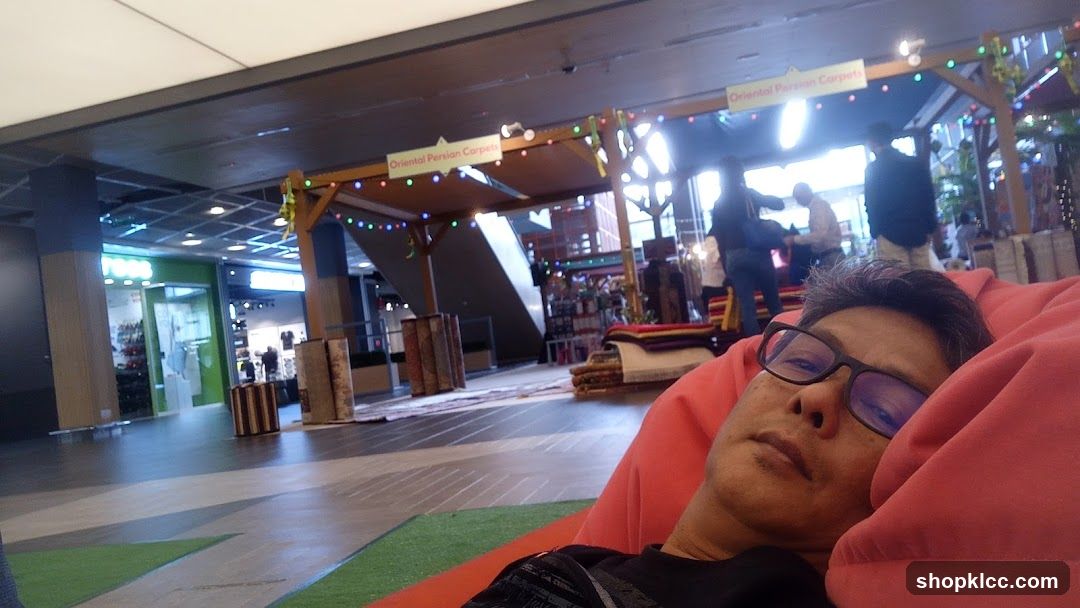 Man relaxing in a beanbag chair in a mall