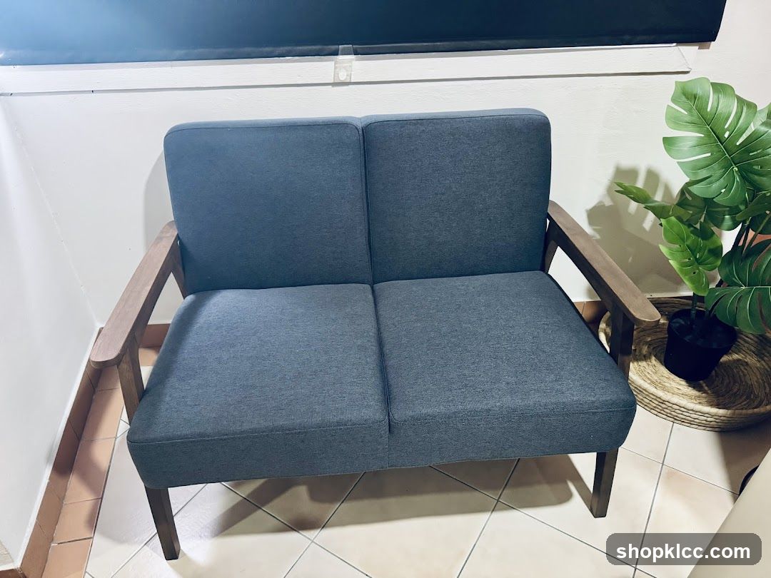 Sofa with wooden arms and a plant