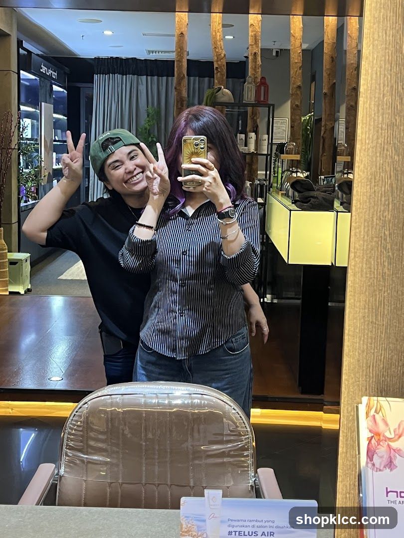 Two people taking a selfie in a salon