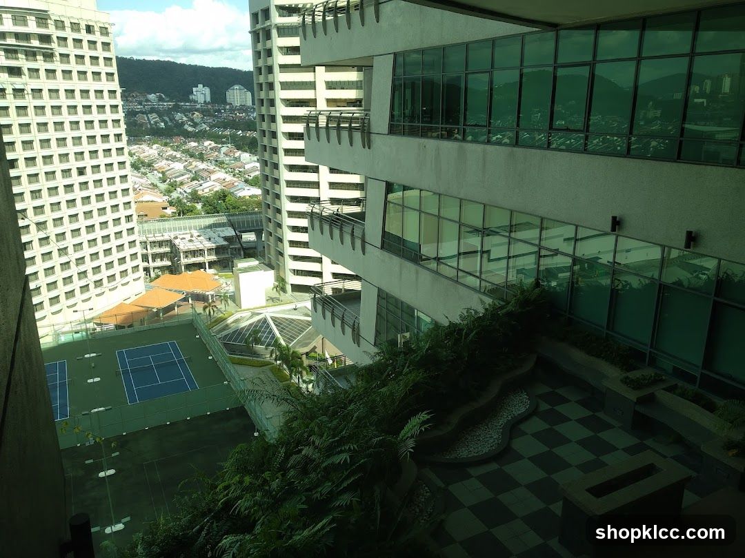 High-rise building exterior with tennis court and city view