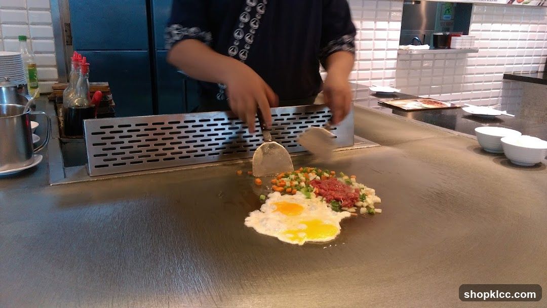 Chef cooking on a teppanyaki grill