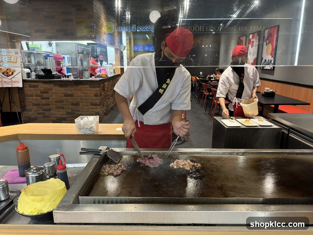 Chefs cooking on a teppanyaki grill
