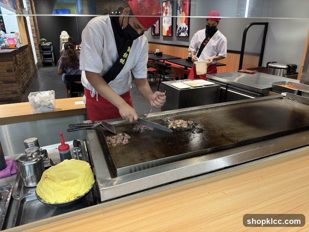 Chefs cooking at a teppanyaki grill