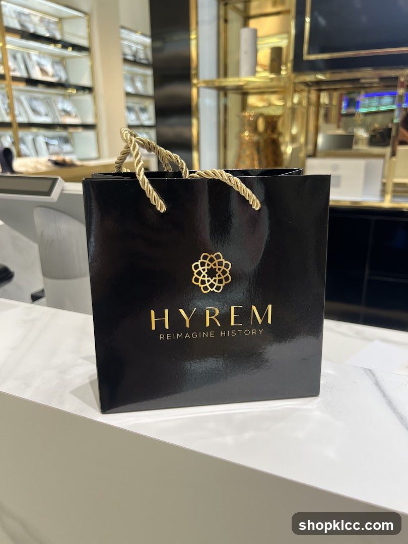 Black shopping bag with gold logo