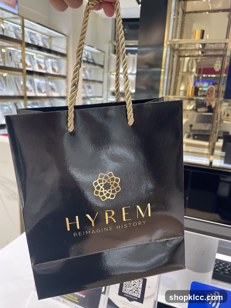 Black shopping bag with gold logo