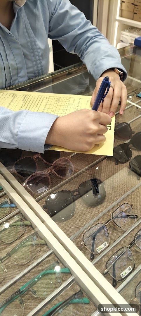 Customer filling out form at optical shop