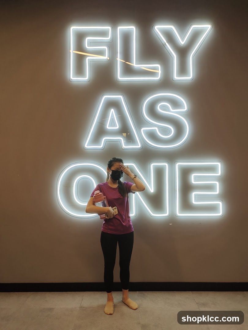 Woman Poses in Front of Neon Sign
