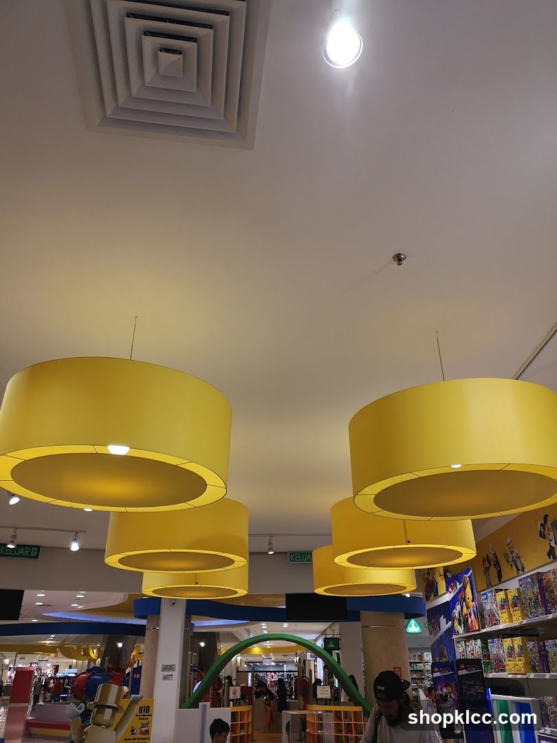 Interior of a brightly lit store with large yellow lamps