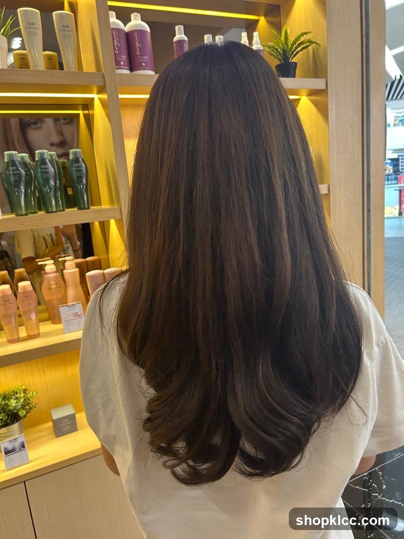 Woman with long brown hair in a salon
