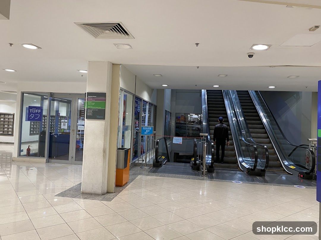 Mall Interior with Escalators and Storefronts