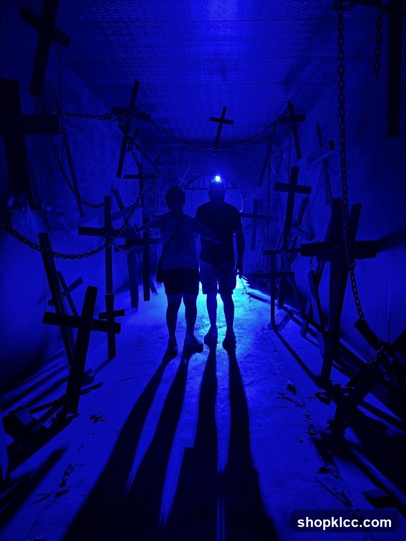 Blue-lit corridor with crosses and chains