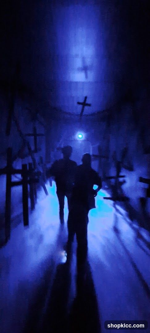Blue-lit corridor with crosses and silhouettes