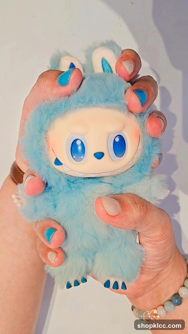 Blue Furry Toy Held in Hands