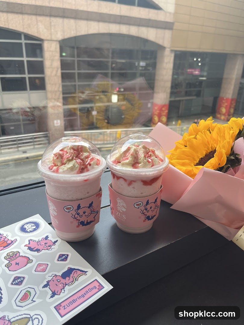 Two strawberry milkshakes with whipped cream and a bouquet of sunflowers