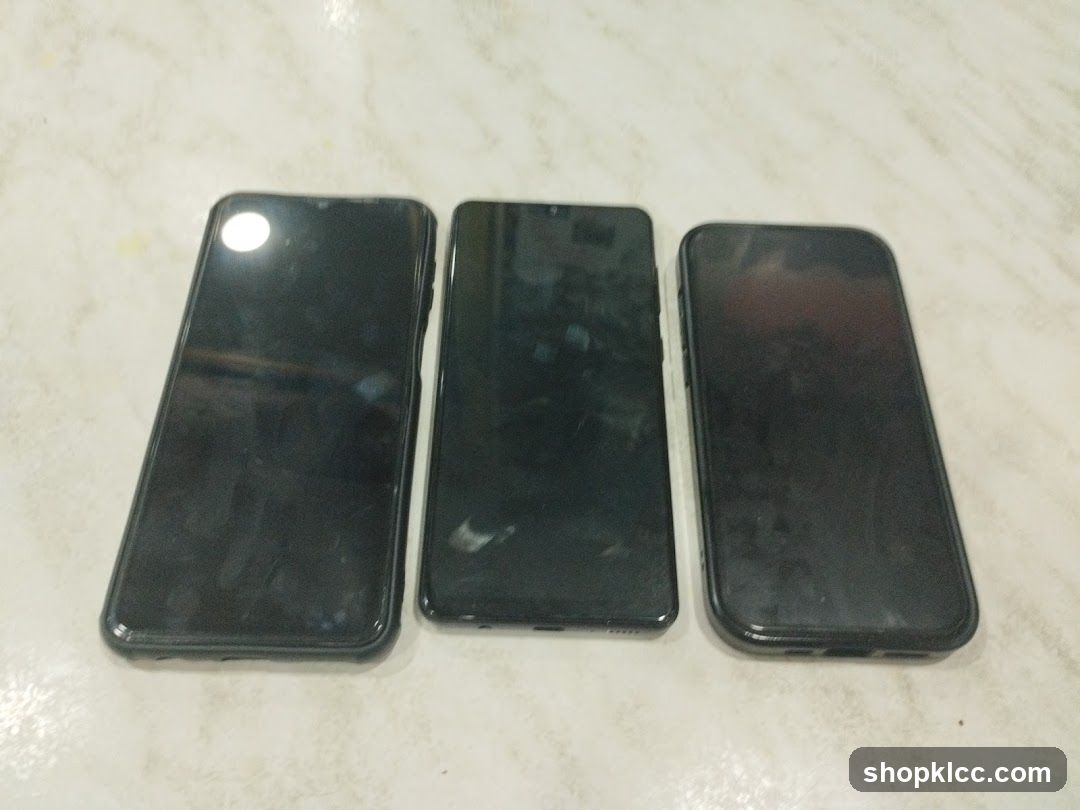 Three smartphones on a marble surface