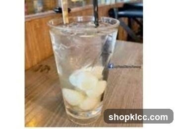 Glass of water with ice and straws