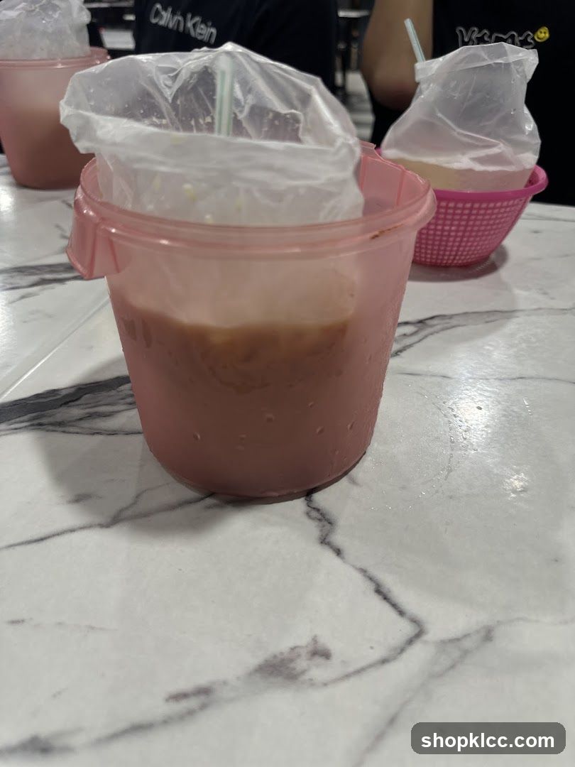 Beverages in plastic cups on table