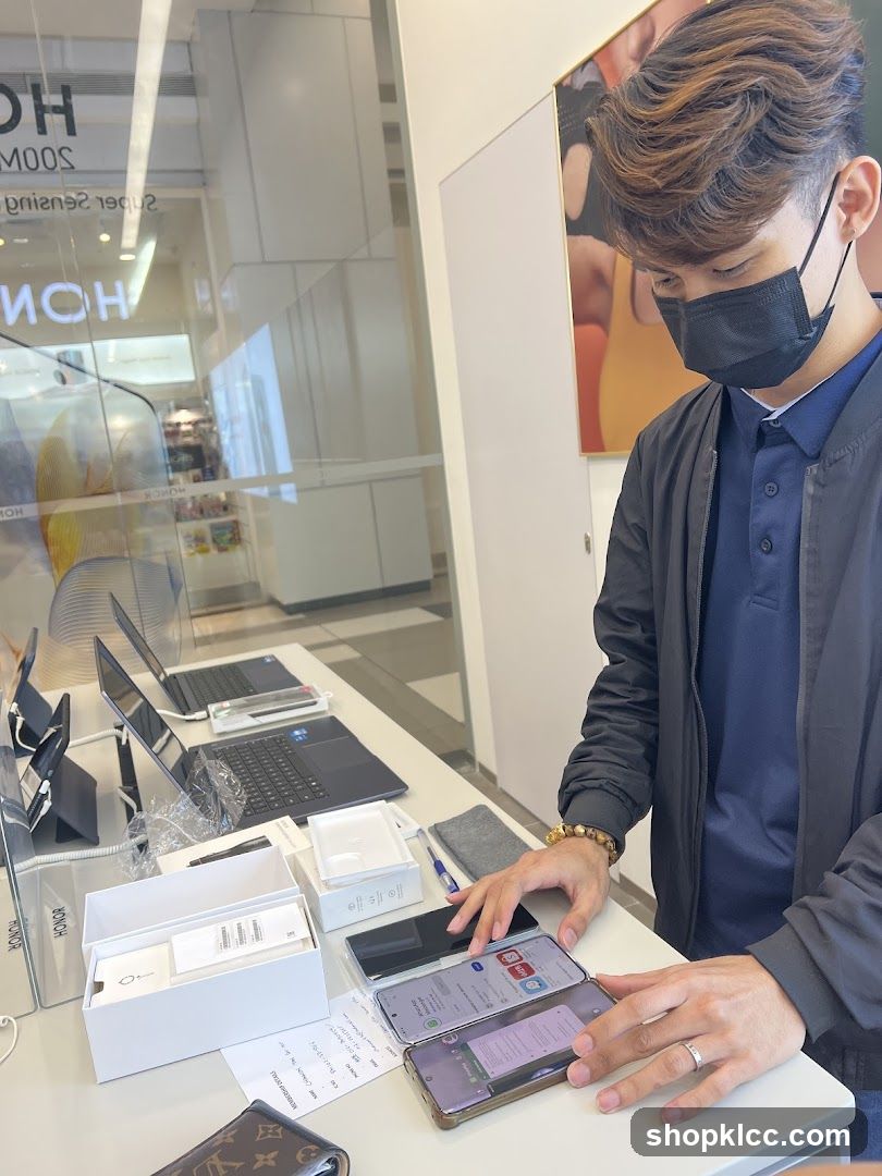 Man demonstrating smartphones in a store
