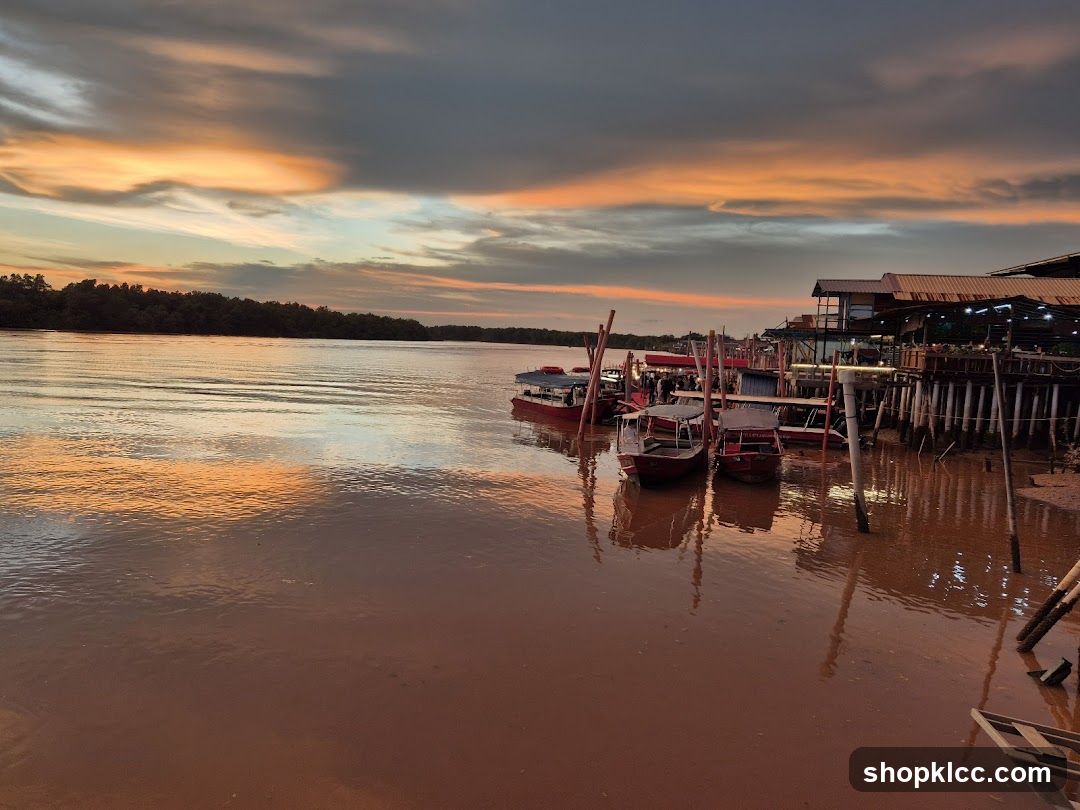 River Sunset with Boats and Stilt Houses