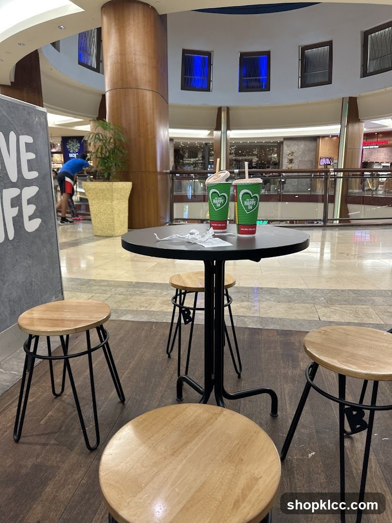 Table with drinks and stools in a mall
