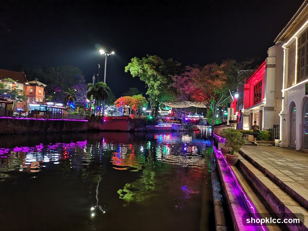 Night canal scene with illuminated buildings and reflections