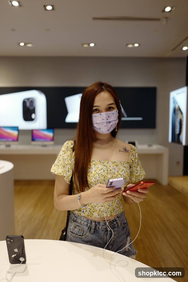 Woman holding phones in electronics store