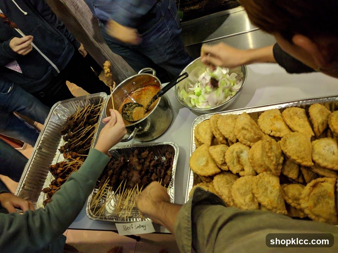 Food spread with satay and pastries