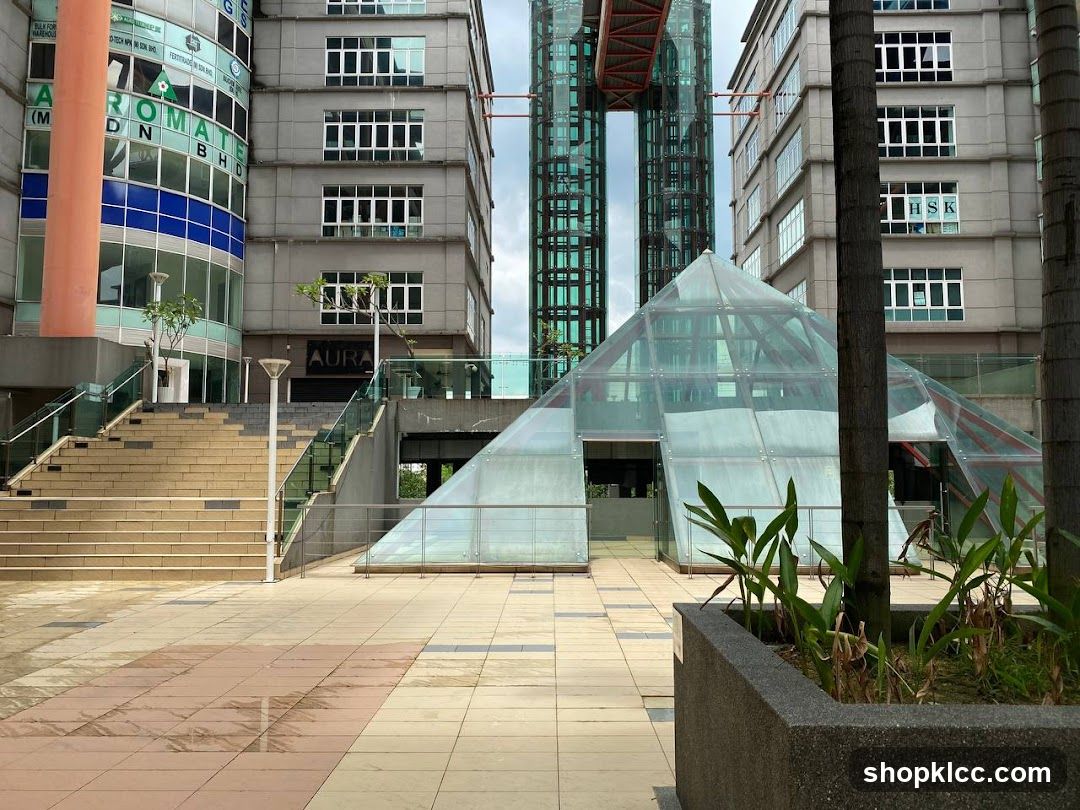 Modern Building Complex with Glass Pyramid Entrance