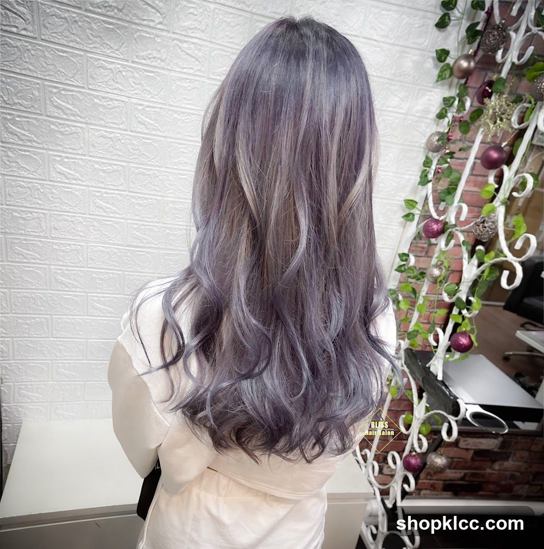 Woman with long, wavy, purple-grey hair
