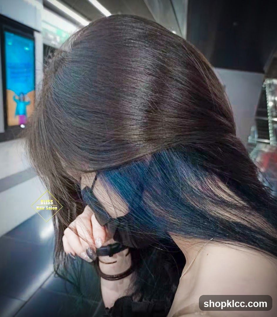 Woman with dark hair and blue highlights
