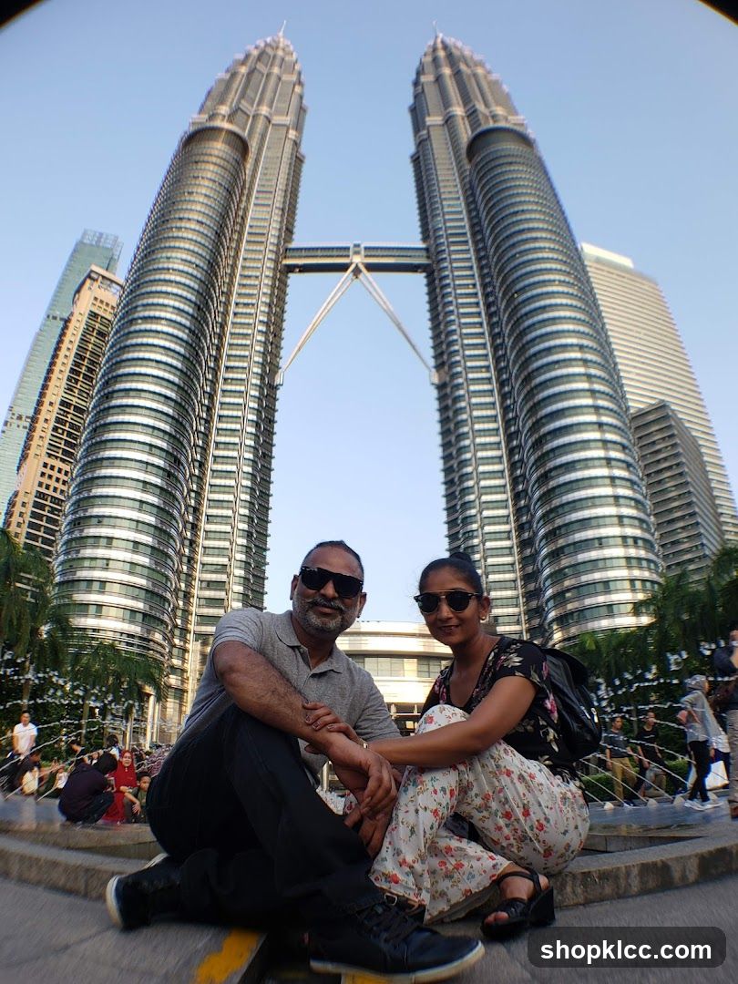 Couple Posing in Front of Petronas Towers