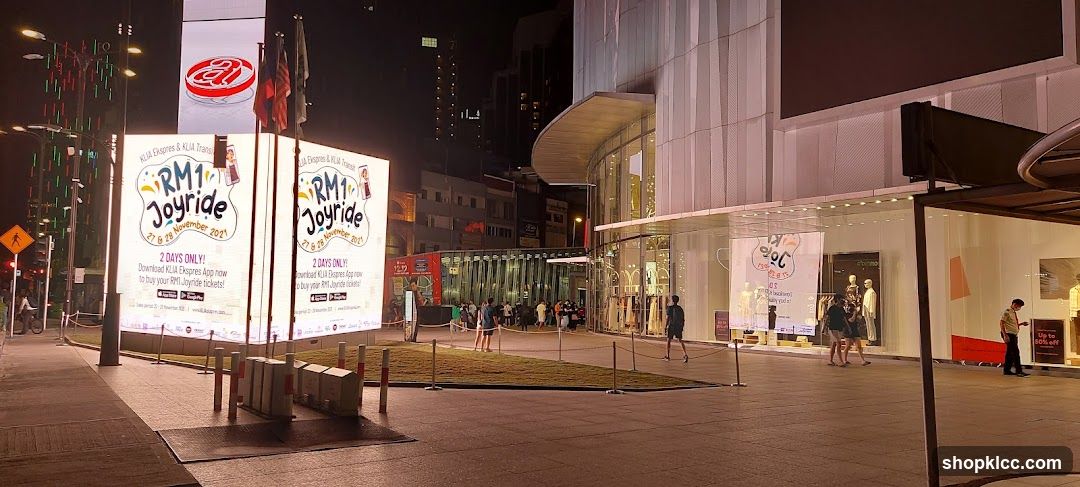 Outdoor advertisement and storefronts at night