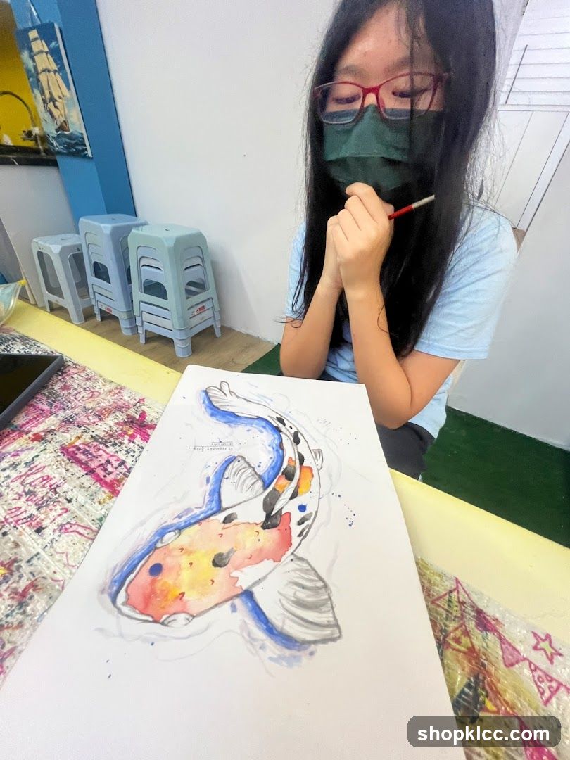 Young artist painting a koi fish