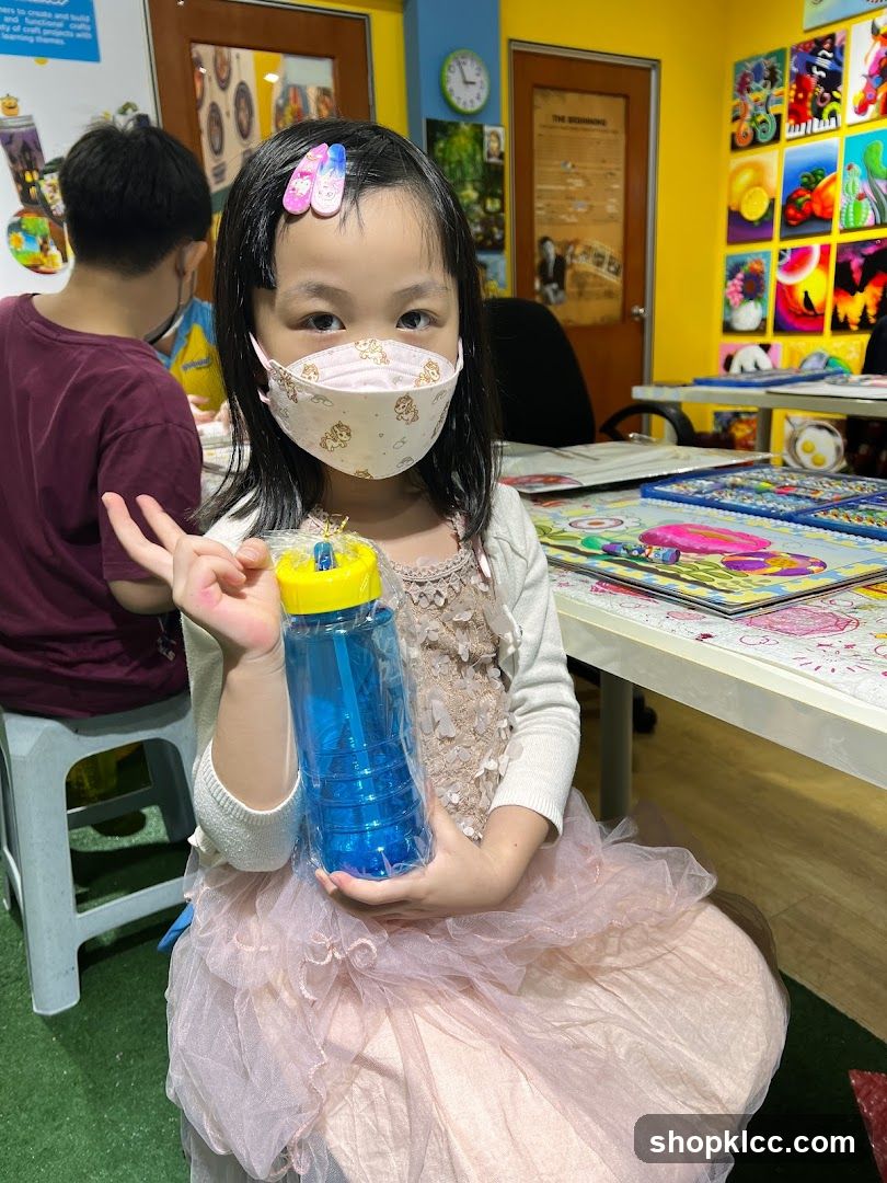 Child holding a blue bottle
