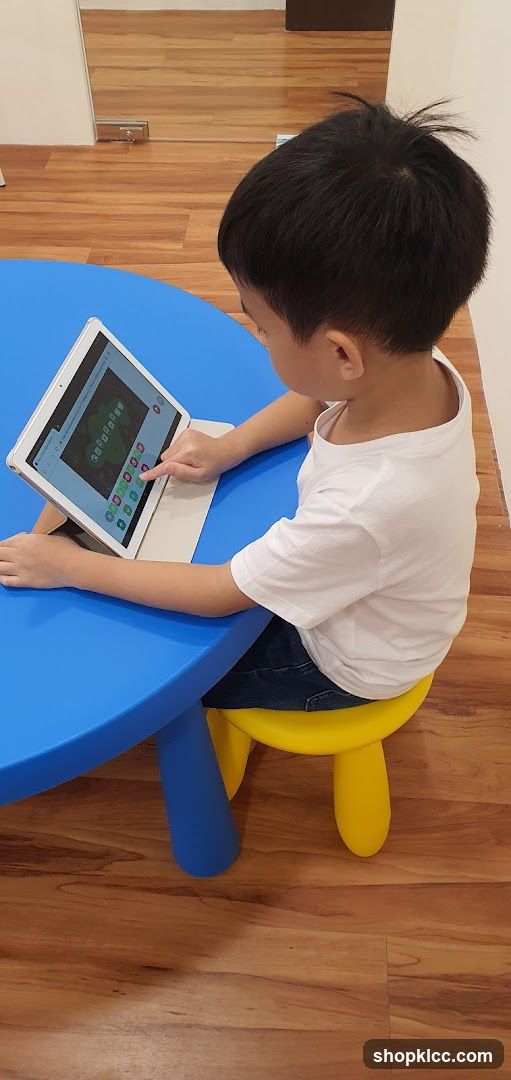 Child using a tablet at a table