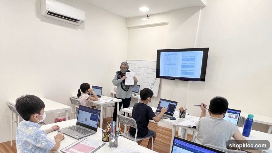 Children in a classroom learning on laptops