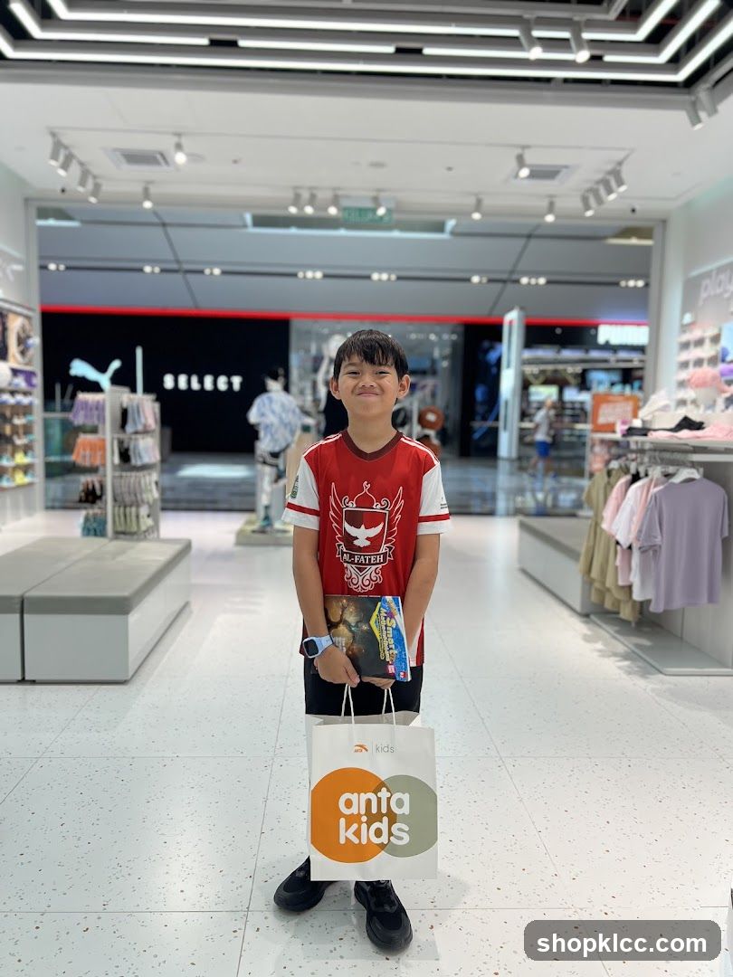 Boy holding shopping bag and book in store