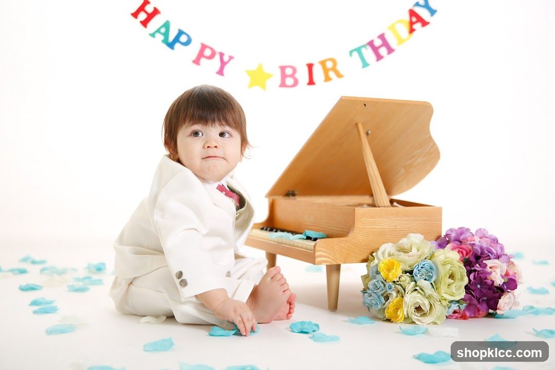 Baby in a suit with a toy piano