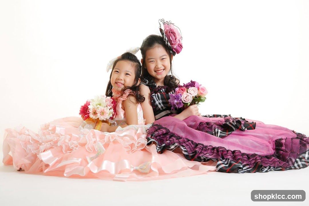Two girls in formal dresses holding bouquets