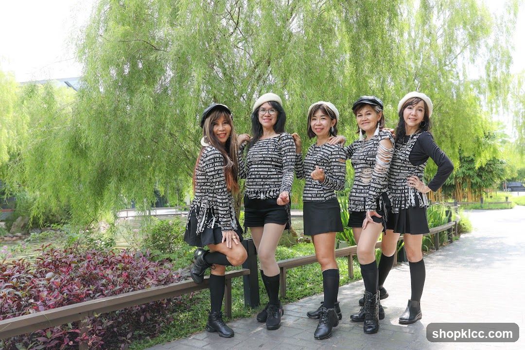 Five women posing in a park