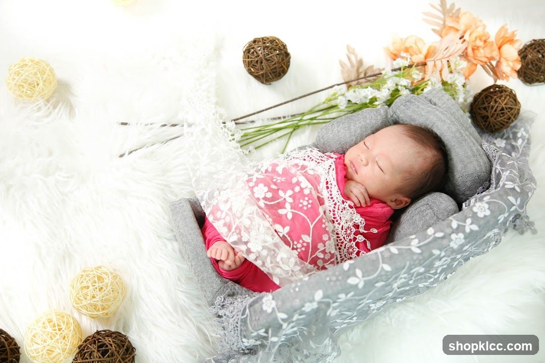 Newborn baby sleeping in a basket with floral decorations