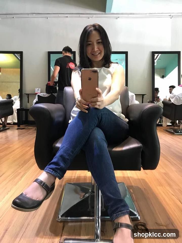 Woman Taking Selfie in Hair Salon