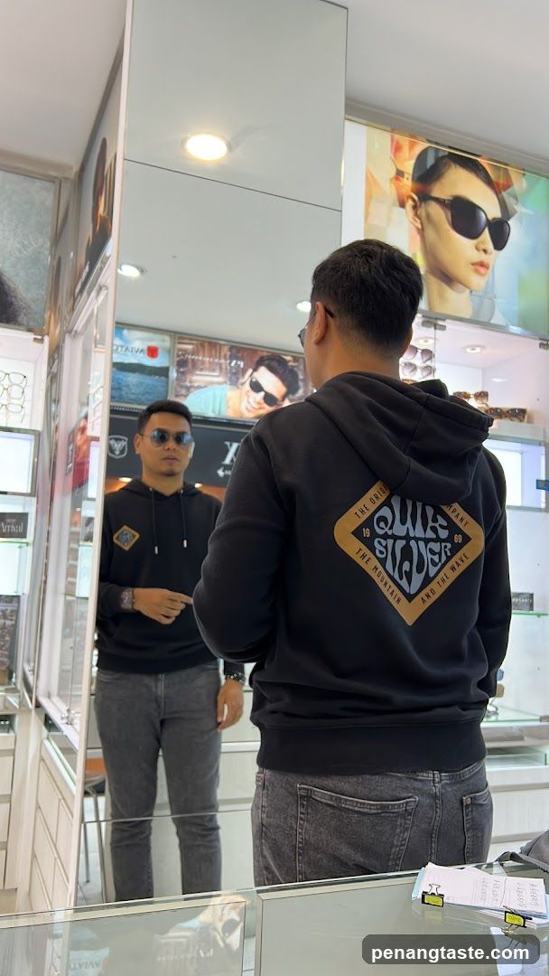 Man trying on sunglasses in a store
