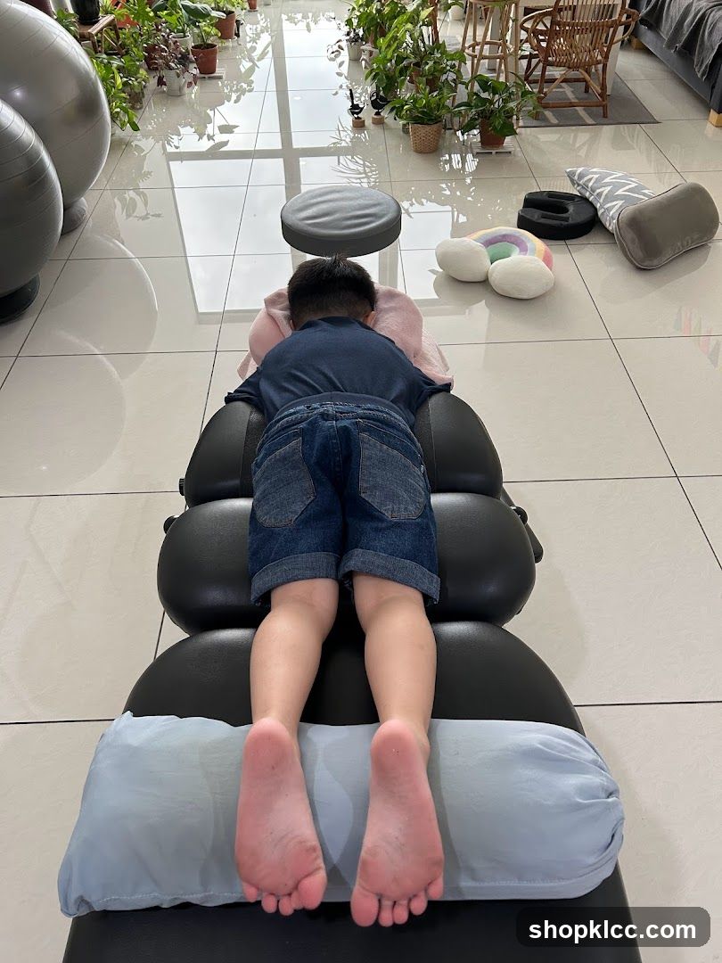 Child lying on massage table